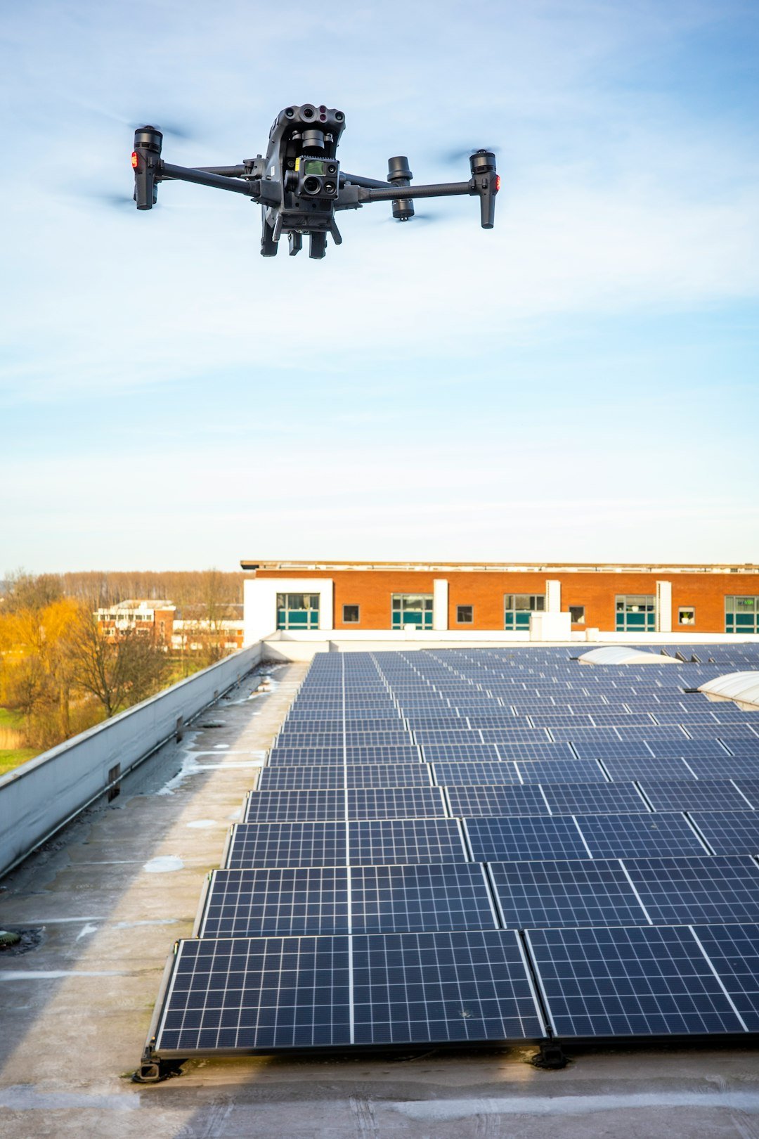 Drone inspecting solar panel array. Thermal camera inspection.